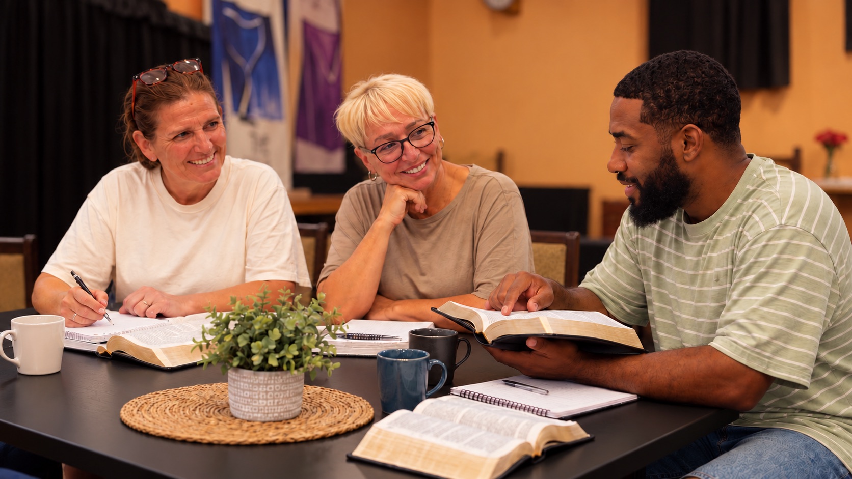 Three students reading and discussing Scripture together